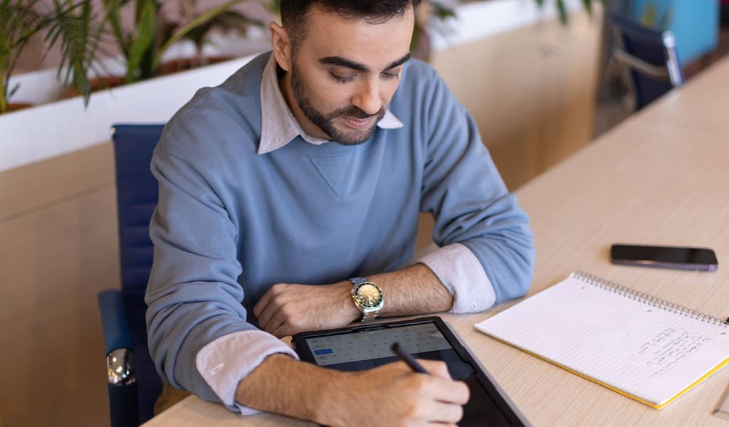 Man writing with tablet.
